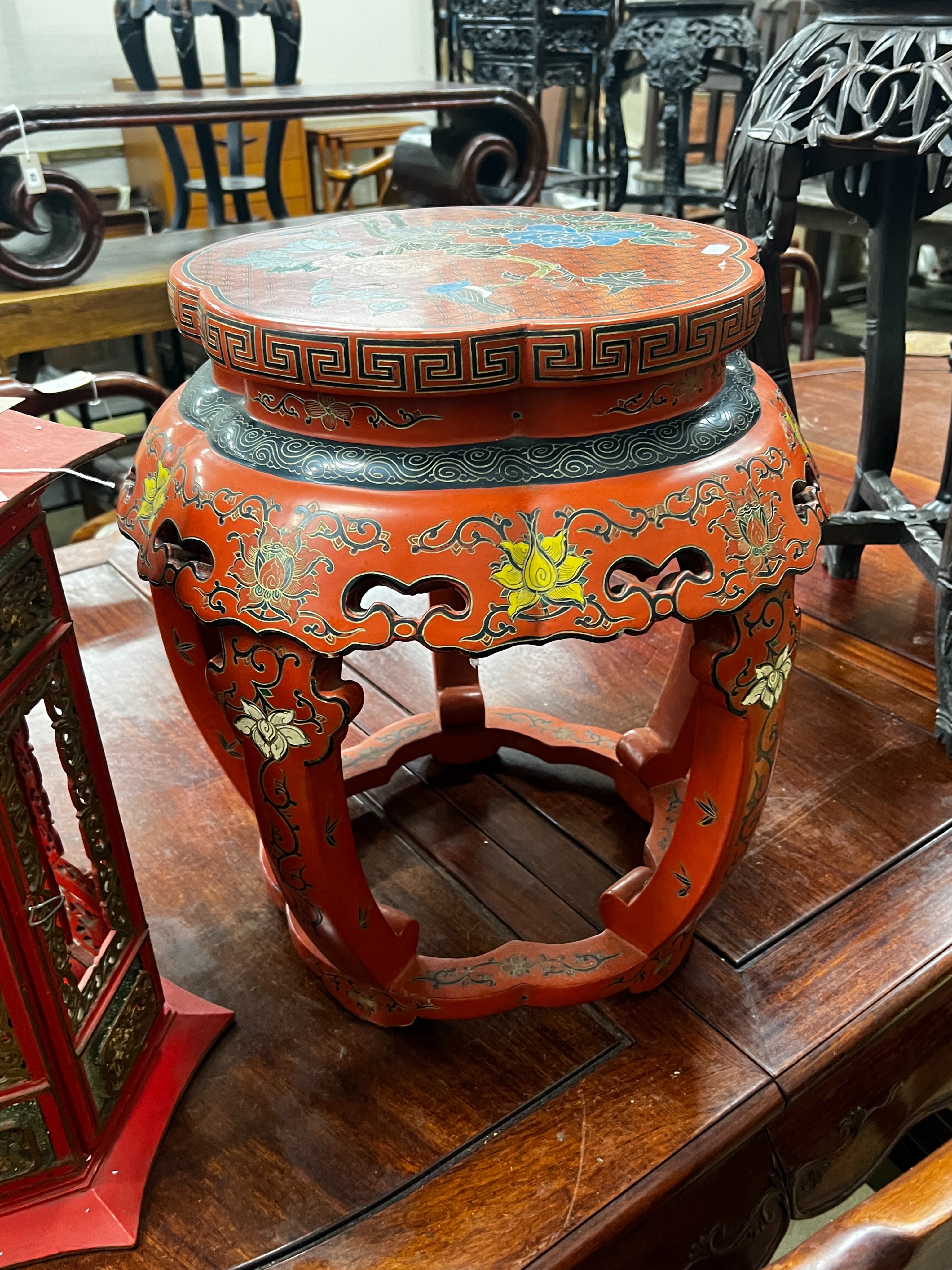 A Chinese red lacquer circular vase stand, diameter 44cm, height 47cm together with a similar Chinese red painted parcelgilt lantern, height 41cm